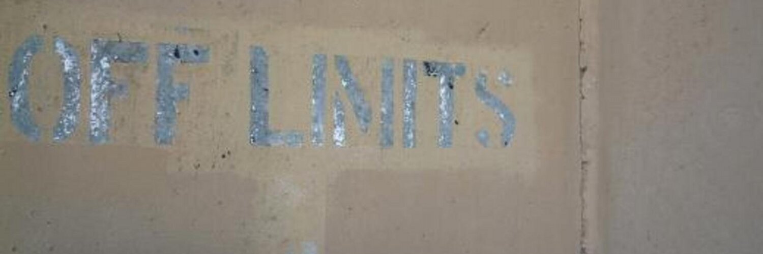 Photo of a concrete wall with the words OFF LIMITS stenciled on.